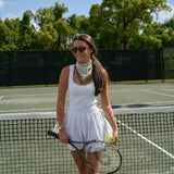 Woman wearing the Sevy Lake Shore UPF 50+ sun bandana in Moss for tennis
