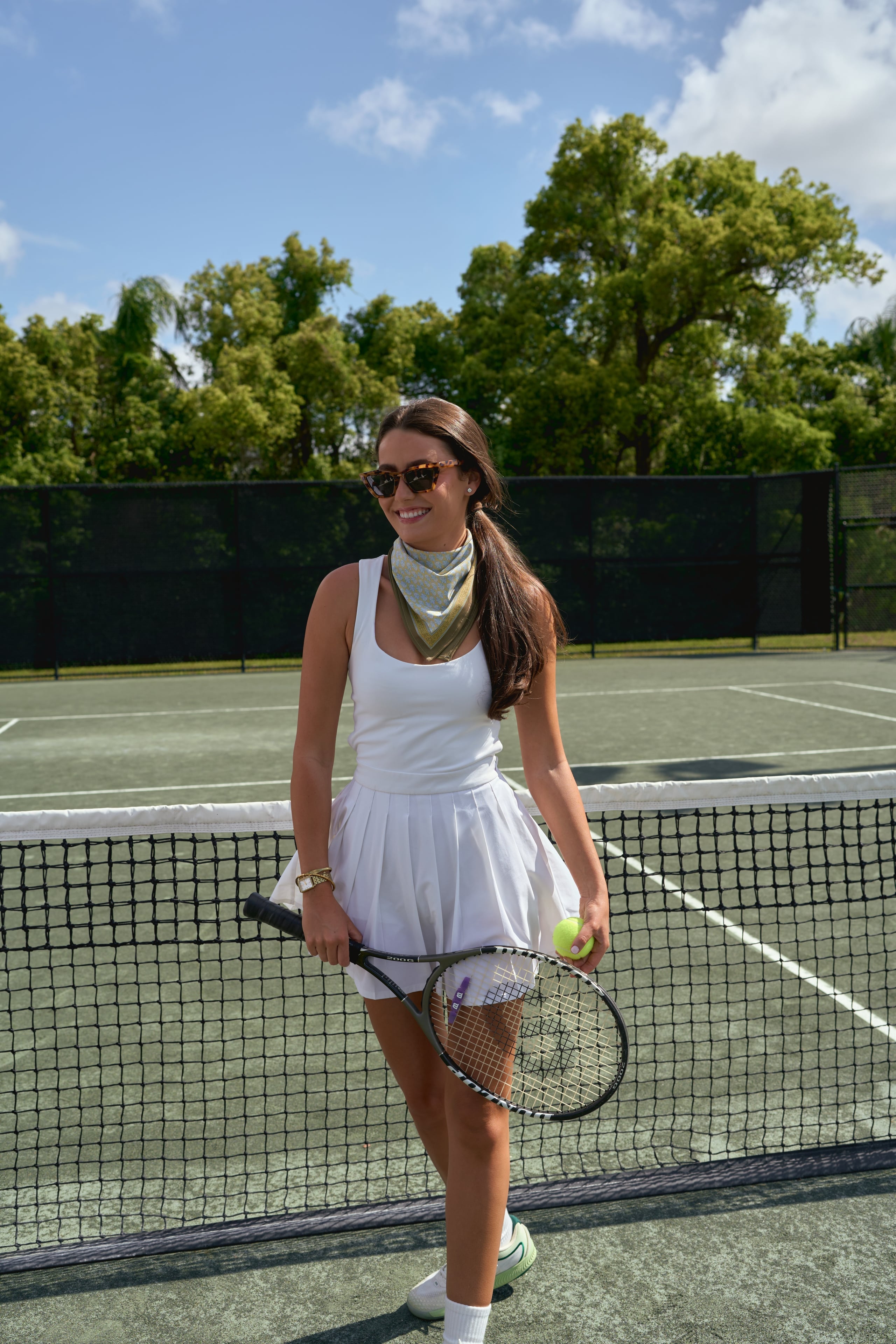 Woman wearing the Sevy Lake Shore UPF 50+ sun bandana in Moss for tennis
