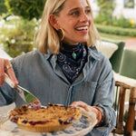 Woman wearing the Sevy Sea Ranch UPF 50+ sun bandana in Marine navy