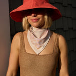 Woman wearing the Sevy Sea Ranch UPF 50+ sun bandana in Sunset