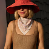 Woman wearing the Sevy Sea Ranch UPF 50+ sun bandana in Sunset